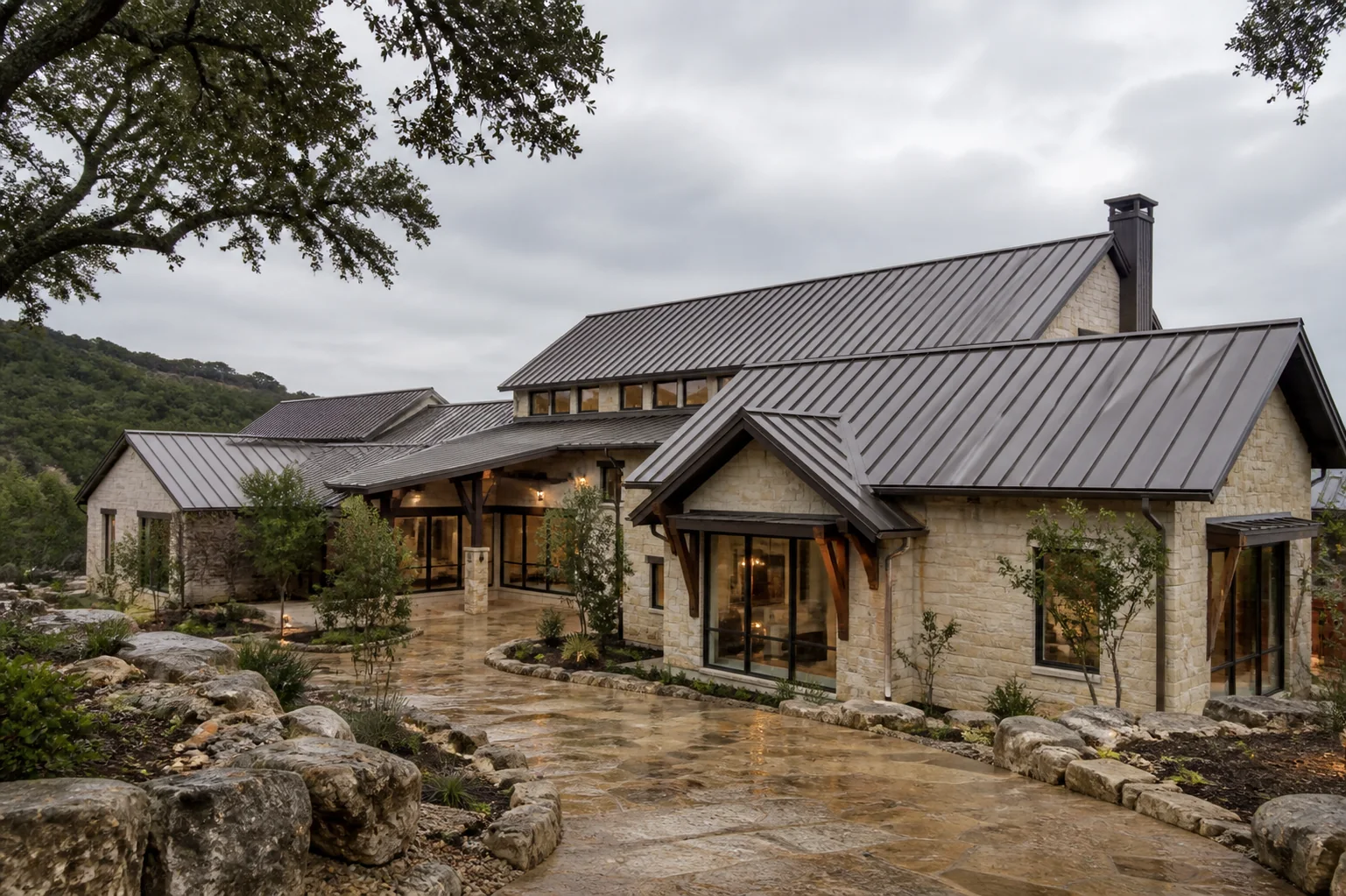 Completed standing-seam metal roof on a limestone Hill Country home
